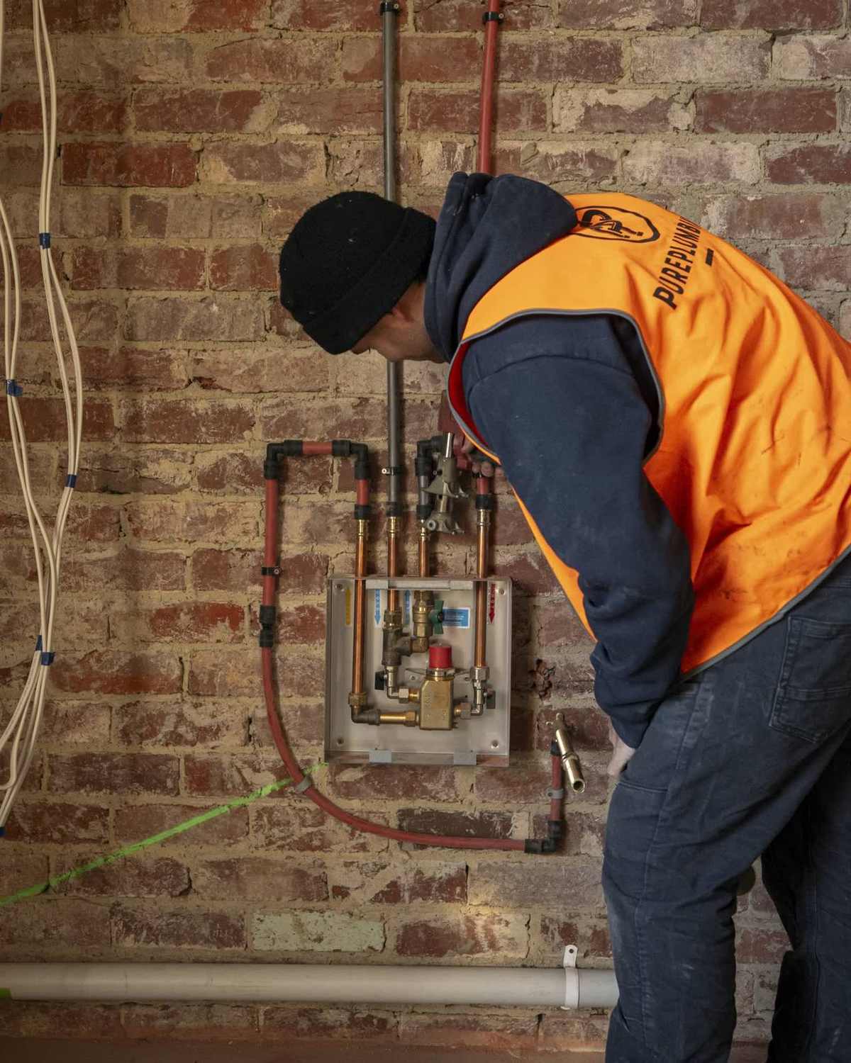 Pure Plumbing technician repairing a kitchen mixer tap